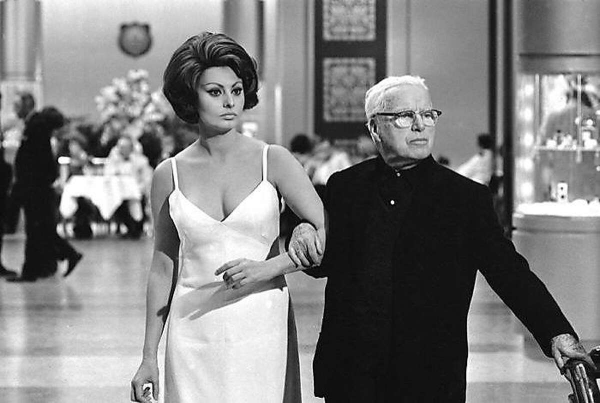Showing how he wants each scene played, Charlie Chaplin demonstrates for Sophia Loren, who plays the countess, in Chaplin's film, "A Countess from Hong Kong" in Pinewood Studios, near London, on April 11, 1966. (AP Photo)
