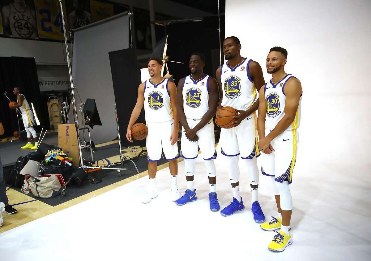 (R-L) Stephen Curry, Kevin Durant, Draymond Green and Klay Thompson pose for a picture during the Golden States Warriors media day on September 22, 2017 in Oakland.