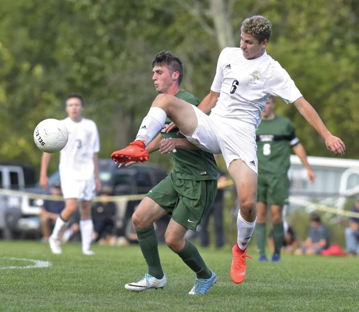 Barlow's Jack Warren (6) kicks away the ball in front of New Milford's Shane Fedigan (14) in the boys soccer game between New Milford and Joel Barlow high schools, Thursday afternoon, September 28, 2017, at Joel Barlow High School, in Redding, Conn.