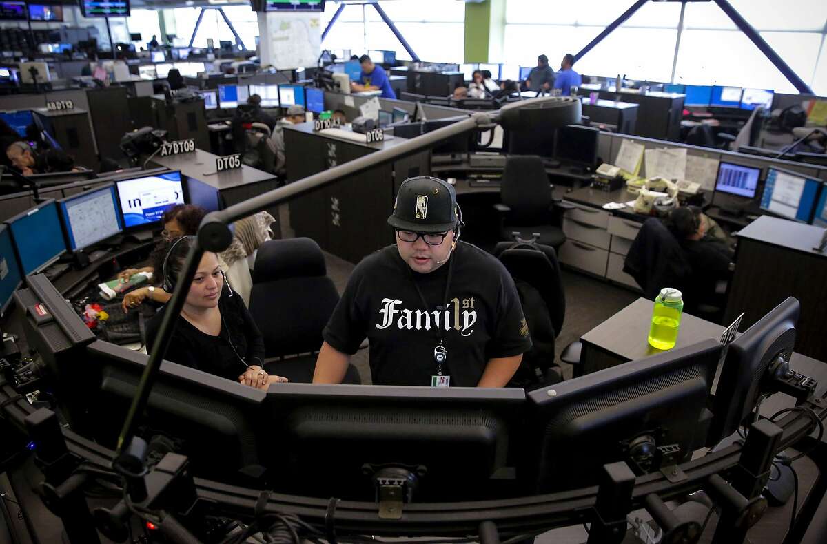 Dispatcher Debora Zambrano, (left) with Arnel Laxa, a trainee at the San Francisco 911 Emergency Call Center on Mon. July 31, 2017 in San Francisco, Ca.
