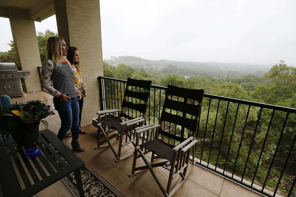 Boerne resident Natalie Sales and her daughter, Morgan, look out into the Hill Country from their balcony on Thursday, Sept. 28, 2017. Sales her family moved into the town over four years ago. Growing up in Ohio and then starting a family in the Rio Grande Valley, Sales and her husband found Boerne a charming town with good schools to raise their two daughters. Boerne's population has tripled in the last three decades. Over 5,000 new homes are planned over the next several years. Kendall County was the second fastest-growing county in the U.S. among those with population sizes of 10,000 or more. (Kin Man Hui/San Antonio Express-News)