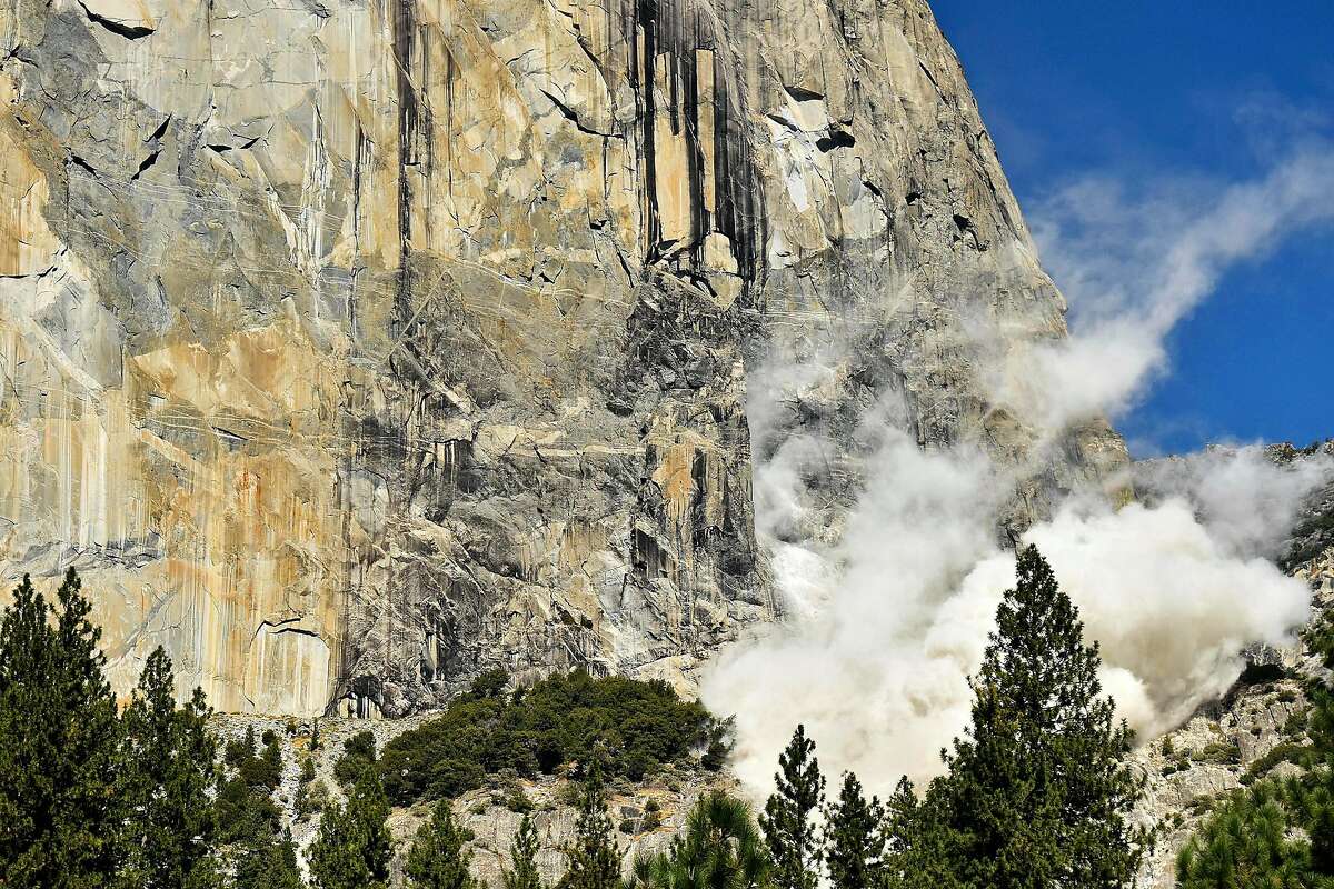 In this Wednesday Sept. 27, 2017, photo provided the National Park Service, a cloud of dust is seen on El Capitan after a major rock fall in Yosemite National Park, Calif. An official says the man killed when a massive hunk of rock fell of Yosemite National Park's El Capitan monolith was a British climber. Yosemite park ranger and spokesman Scott Gediman said Thursday that the man was with a British woman who was seriously injured. (Tom Evans/National Park Service via AP)