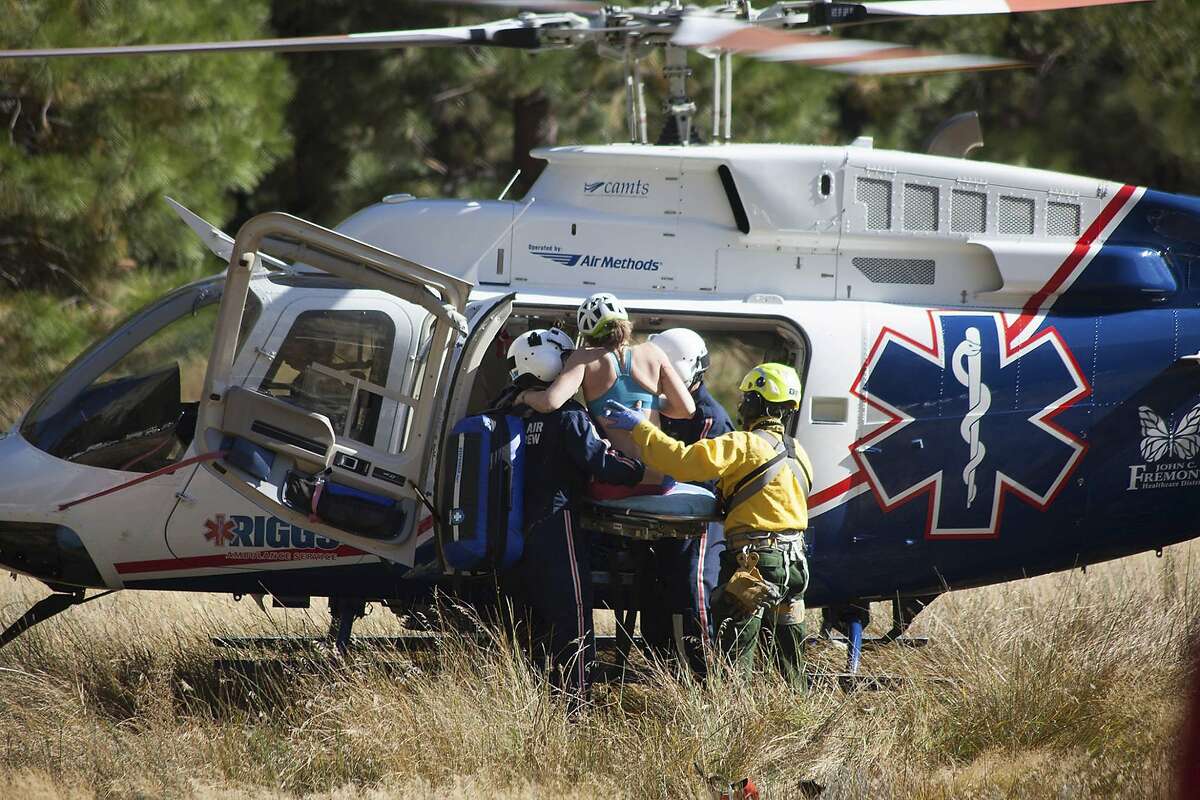 In this Wednesday, Sept. 27, 2017, photo provided by Dakota Snider, photographer and Yosemite resident, a woman is carried into a helicopter after being rescued off El Capitan following a major rock fall in Yosemite National Park, Calif. All areas in California's Yosemite Valley are open Thursday, a day after the fatal rock fall. (Dakota Snider via AP)