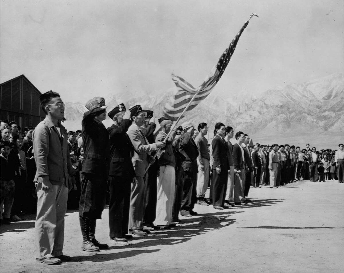 Japanese American Boy Scouts and American Legionaires hold Memorial Day services at the Manzanar Relocation Camp in California, 1942. | Location: Manzanar Relocation Center, California, USA. (Photo by Library of Congress/Corbis/VCG via Getty Images)