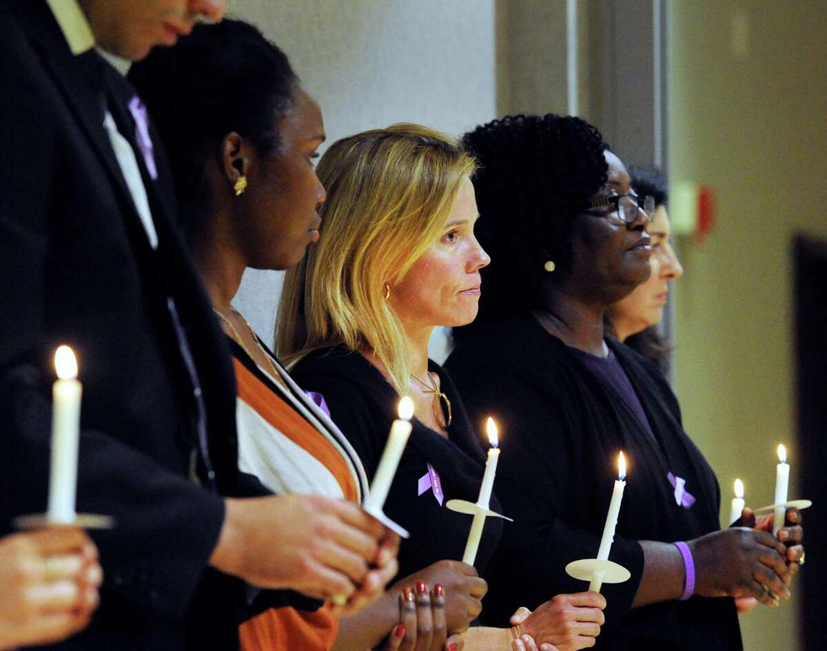 At center, Brooke Bremer of Greenwich, along with other people, holds a candle in memory of victims of domestic abuse during the YWCA Greenwich’s annual candlelight vigil in 2016. YWCA Greenwich will begin a month’s series of events designed to raise awareness and funds for its 24/7 services for domestic abuse victims and their families.