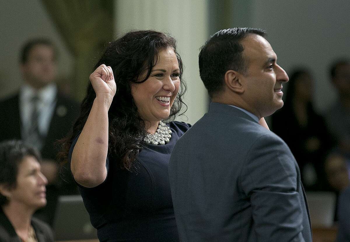 Assemblywoman Lorena Gonzalez Fletcher, D-San Diego, flanked by Assemblyman Ash Kalra, D-San Jose, celebrates as the "sanctuary state" bill she carried in the Assembly was approved, Friday, Sept. 15, 2017, in Sacramento, Calif. The bill, SB54, by Senate President Pro Tem Kevin de Leon, D-Los Angeles, would limit police cooperation with federal immigration authorities, now goes to the Senate for final approval.(AP Photo/Rich Pedroncelli)