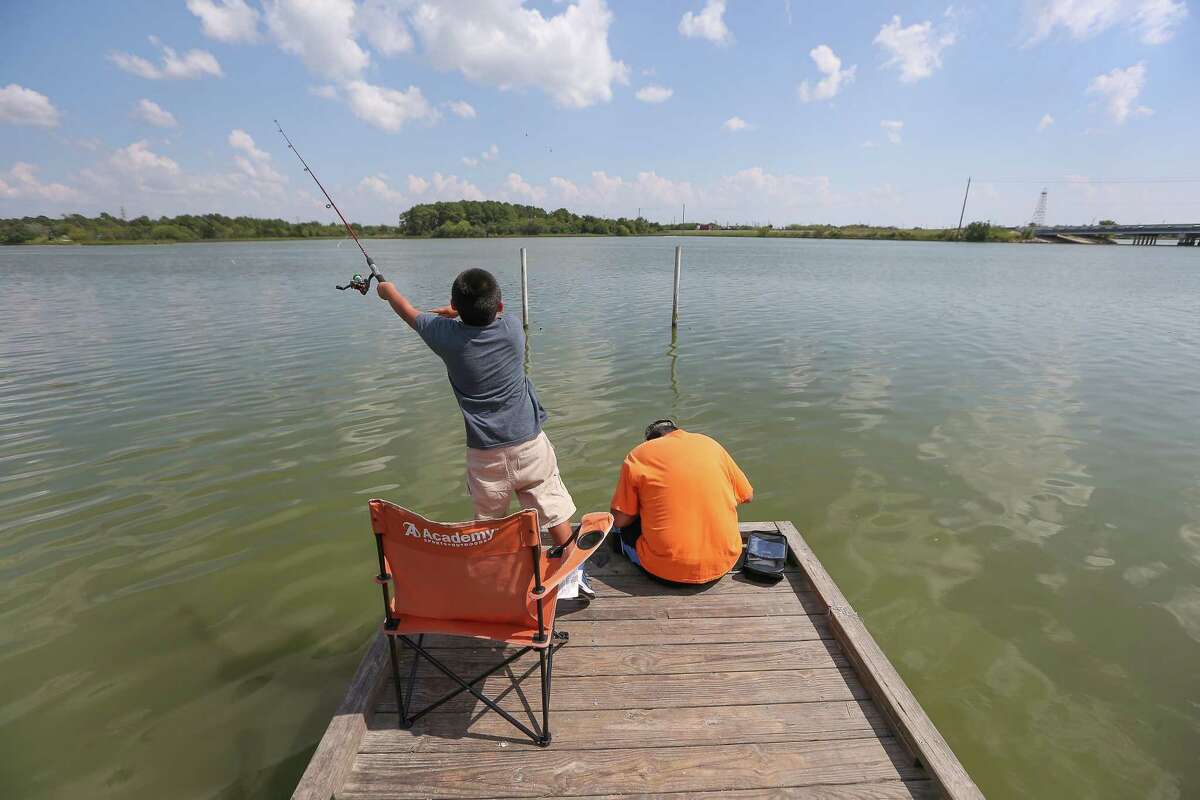 Sampson Mann, 7, casts ﻿a line ﻿with his neighbor Eddie Yazie﻿ at W.C. Britton Park ﻿in Baytown. The water is showing higher than normal ﻿contamination﻿.﻿