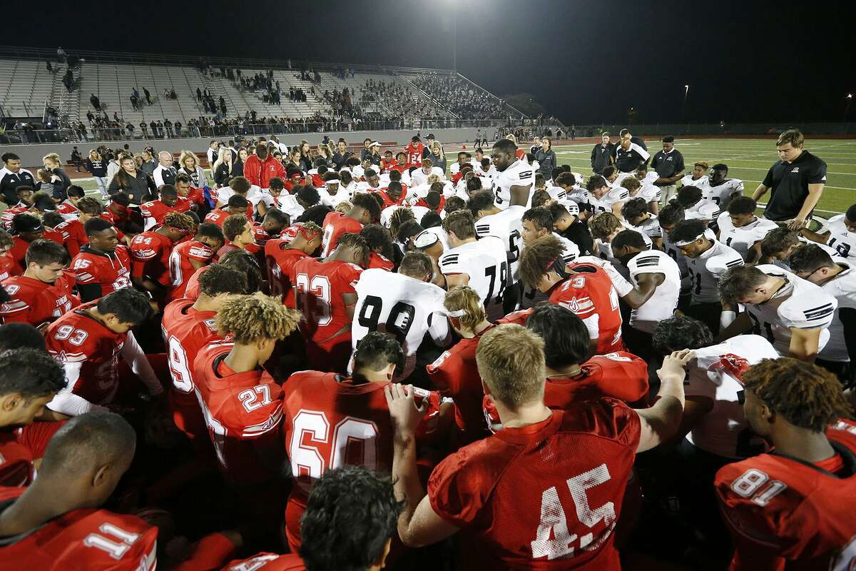 Members of the Judson Rockets and Steele Knights pray after their game Friday Sept. 29, 2017 at Rutledge Stadium. Judson won 35-28.