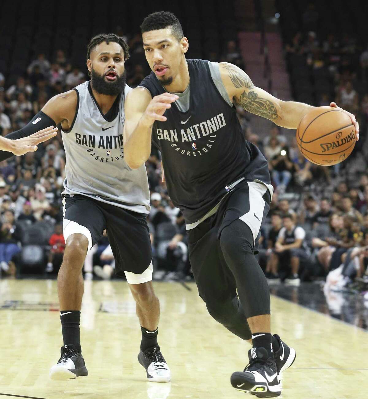 Danny Green gets away from Patty Mills as the Spurs Silver and Black intrasquad scrimmage at the AT&T Center on September 30, 2017.