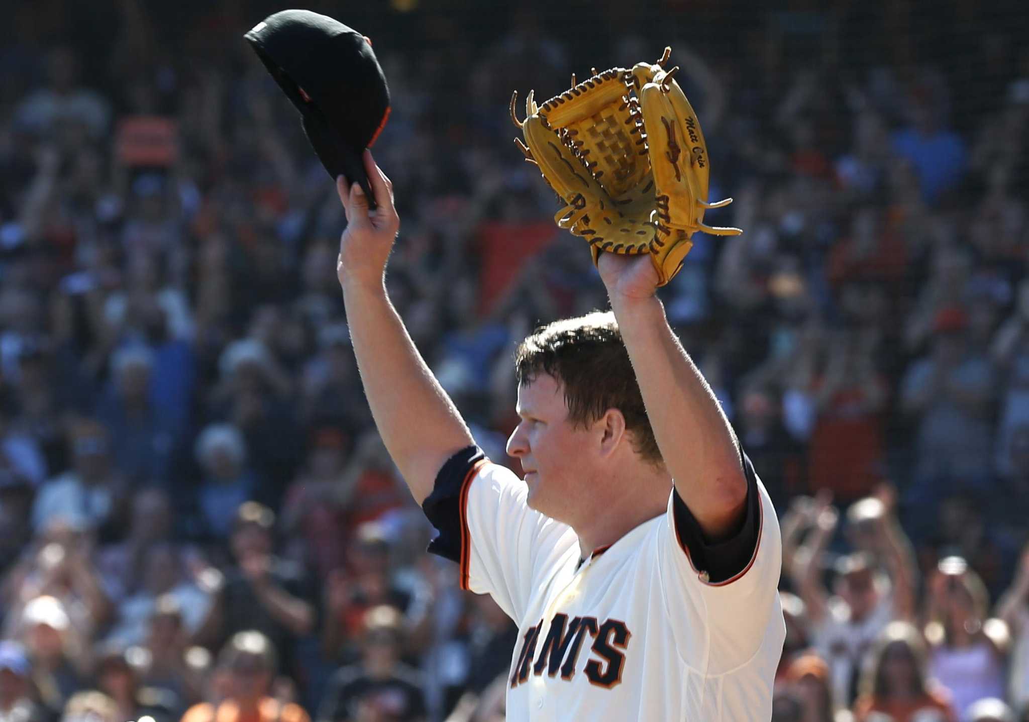 San Francisco Giants manager Bruce Bochey brings out the 2014 World Series  trophy to place it with those won in 2010 and 2012 after the World Series  Parade in San Francisco on