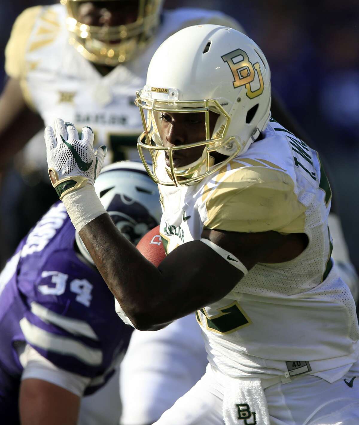 Baylor running back Terence Williams (22) gets past Kansas State defensive end Tanner Wood (34) during the second half of an NCAA college football game in Manhattan, Kan., Saturday, Sept. 30, 2017. Williams announced on Tuesday he will be transferring from Baylor to the University of Houston ad will be eligible to play immediately.(AP Photo/Orlin Wagner)
