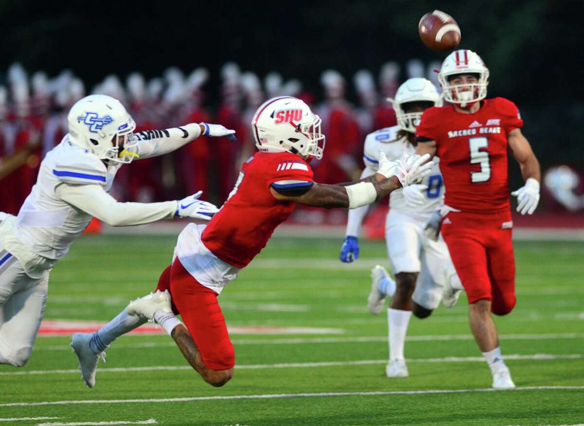 Sacred Heart University's Byron Barney tries to complete a pass sent to him during college football action against Central Connecticut in Fairfield, Conn., on Saturday Sept. 30, 2017.