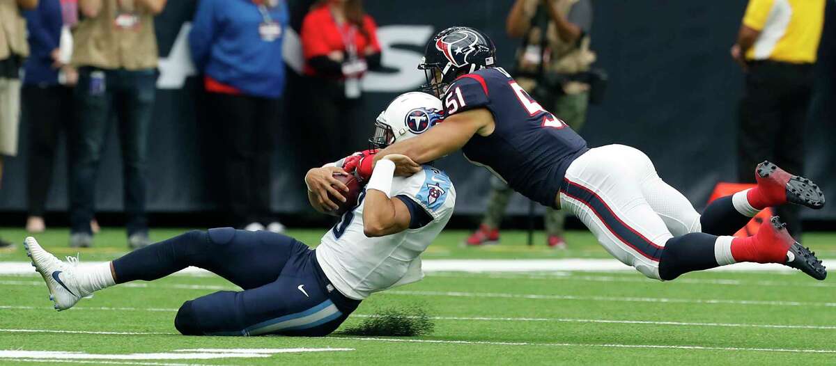 Houston Texans linebacker Dylan Cole (51) tackles Tennessee Titans quarterback Marcus Mariota (8) during the first quarter of an NFL football game at NRG Stadium on Sunday, Oct. 1, 2017, in Houston.
