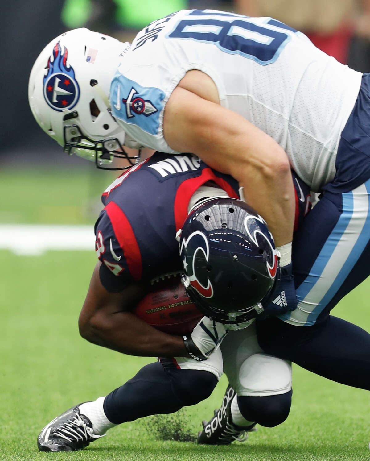Houston Texans running back Tyler Ervin (34) is tackled by Tennessee Titans tight end Phillip Supernaw (89) on a punt return during the first quarter of an NFL football game at NRG Stadium on Sunday, Oct. 1, 2017, in Houston. Ervin left the game with a knee injury.