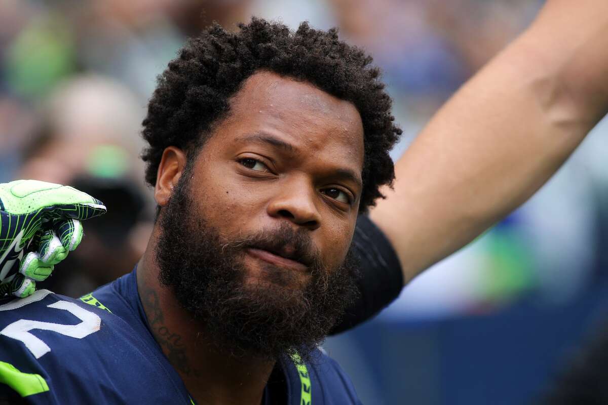Seahawks defensive lineman Michael Bennett as he sits for the National Anthem as a continued protest against police brutality, before Seattle's game against San Francisco, Sunday, Sept. 17, 2017. (Genna Martin, seattlepi.com)