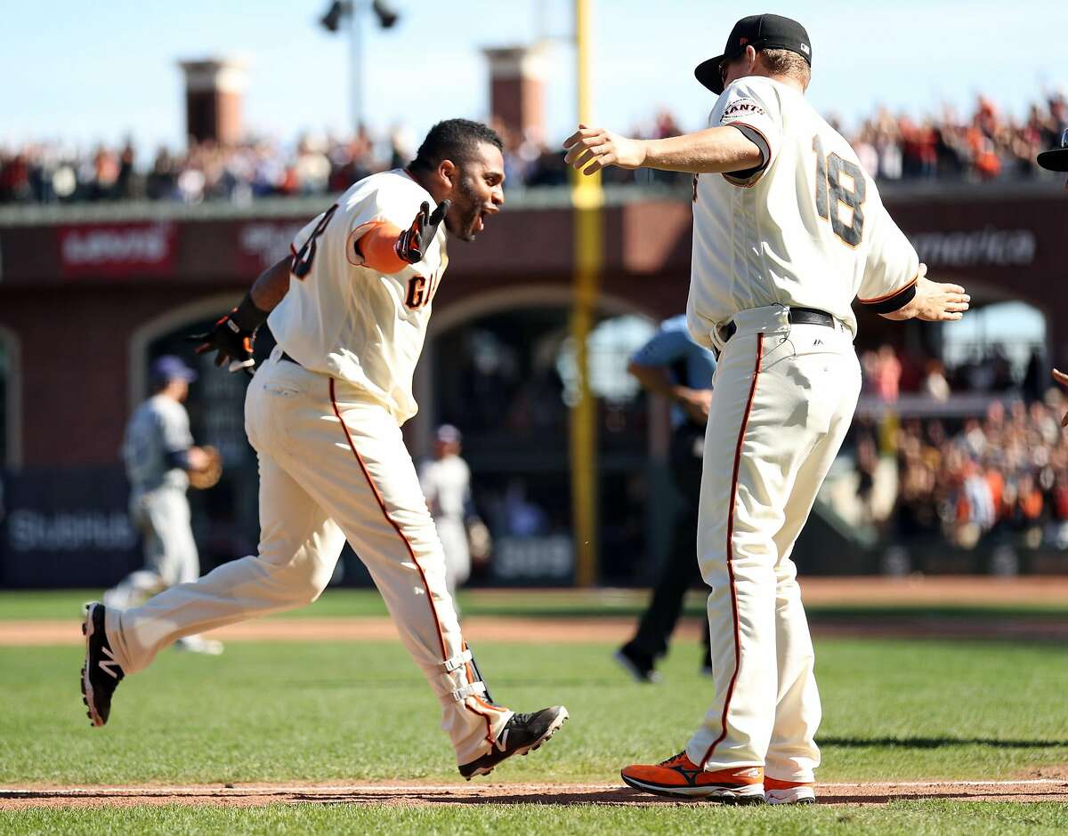 San Francisco Giants' Pablo Sandoval is greeted by Matt Cain after his walk off home run in 9th inning of Giants' 5-4 win over San Diego Padres in MLB game at AT&T Park in San Francisco, Calif., on Sunday, October 1, 2017.