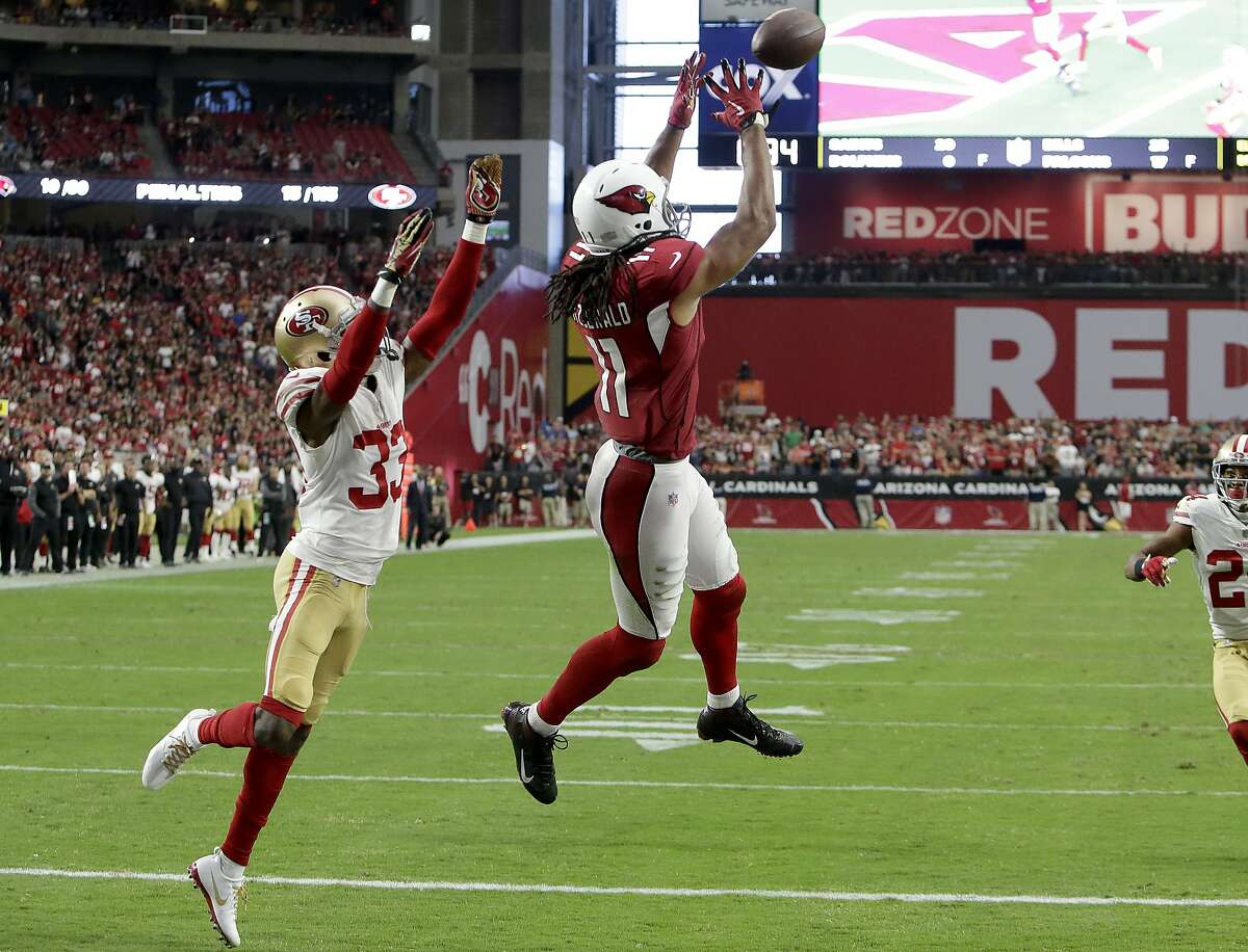 Arizona Cardinals wide receiver Larry Fitzgerald (11) pulls in the game winning touchdown as San Francisco 49ers cornerback Rashard Robinson (33) defends during overtime of an NFL football game, Sunday, Oct. 1, 2017, in Glendale, Ariz. The Cardinals won 18-15. (AP Photo/Rick Scuteri)
