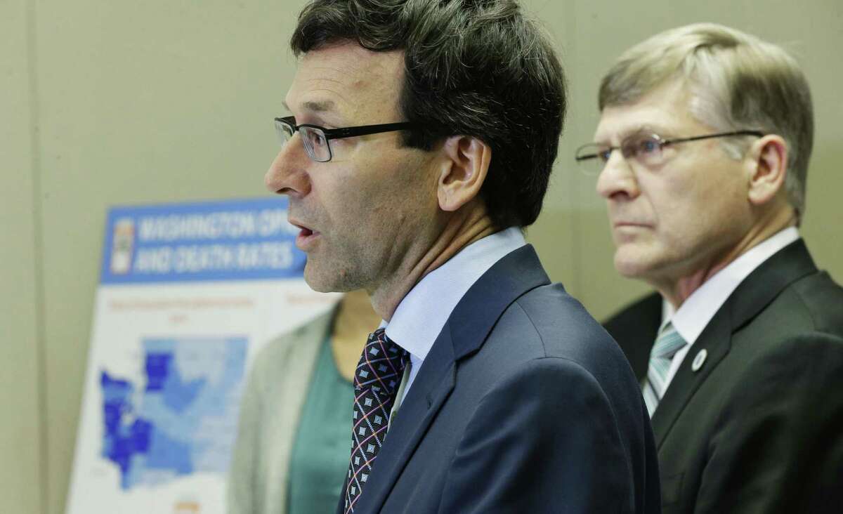 Washington Attorney General Bob Ferguson, center, talks to reporters Thursday, Sept. 28, 2017, in Seattle, as Seattle City Attorney Pete Holmes, right, looks on. Ferguson said Thursday that the state and the city of Seattle are filing lawsuits against several makers of opioids, including Purdue Pharma, seeking to recoup costs incurred by government when the drugs -- which many officials blame for a national addiction crisis -- are abused. (AP Photo/Ted S. Warren)