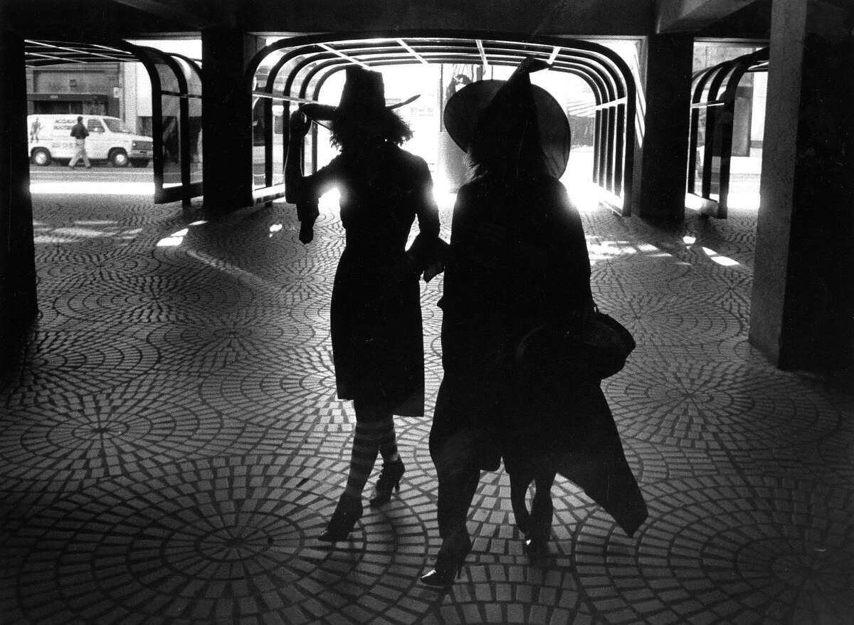 Adults in costume for various Halloween events .. A couple workers with their witch hats return to work at the Embarcadero Center, 10/31/1989