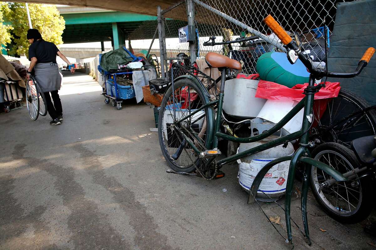 Many bicycles and their parts are found along the sidewalk along Cesar Chavez st., under the 101 freeway as seen on Fri. Sept. 29, 2017, in San Francisco, Ca. There's a bill that San Francisco lawmakers are expected to pass that would make it much more difficult to operate a bicycle chop shop on the city's streets.