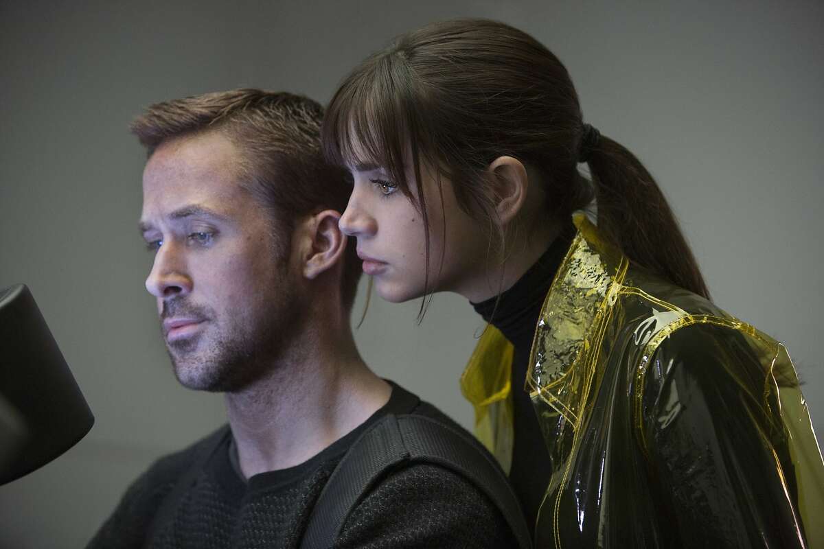 This image released by Warner Bros. Pictures shows Ryan Gosling, left, and Ana de Armas in a scene from "Blade Runner 2049." (Stephen Vaughan/Warner Bros. Pictures via AP)