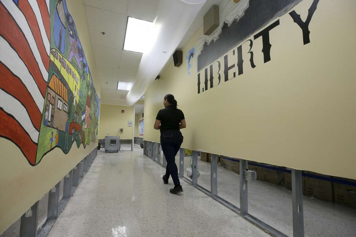 Mary Pinales, with Blackmon Mooring, walks through Liberty High School, 6400 Southwest Fwy., where the walls were cut two feet up to dry out the school Thursday, Aug. 31, 2017, in Houston. Many schools were damaged from flooding in the aftermath of Hurrican Harvey. ( Melissa Phillip / Houston Chronicle )