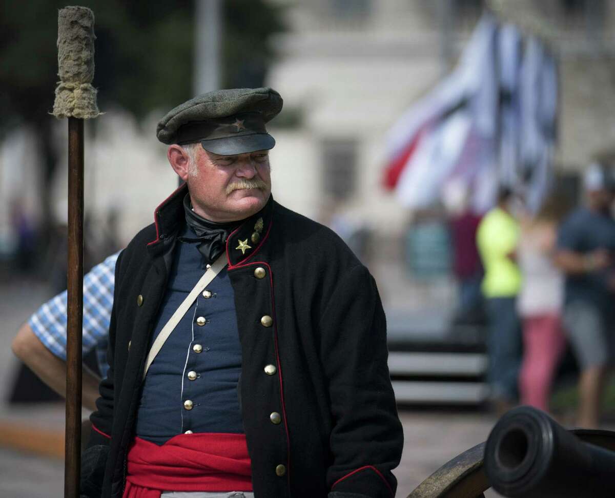 Alamo living historian George Rollow stands by a three-pound cannon during the conclusion of Cannon Fest, Monday, Oct. 2, 2017, at the Alamo in San Antonio. (Darren Abate/For the Express-News)