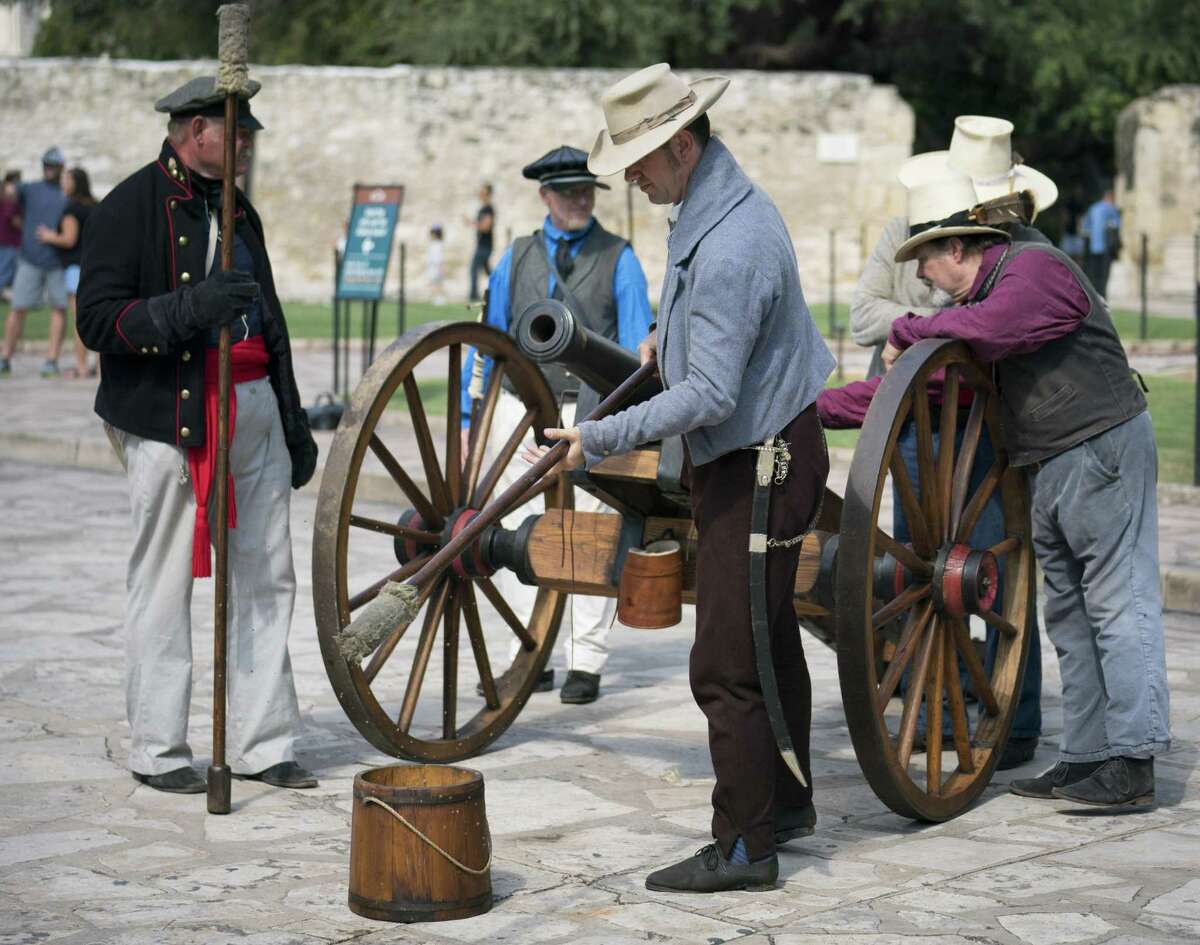 Alamo living historians man a three-pound cannon during the conclusion of Cannon Fest, Monday, Oct. 2, 2017, at the Alamo in San Antonio. (Darren Abate/For the Express-News)