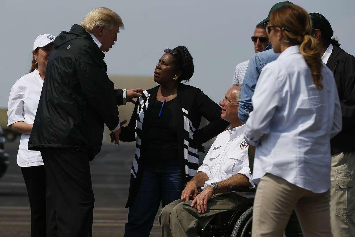 President Donald Trump speaks with congresswoman Sheila Jackson Lee, center, and Texas governor Greg Abbott, right, as he visits Houston in the wake of Tropical Storm Harvey Saturday, Sept. 2, 2017. ( Michael Ciaglo / Houston Chronicle)