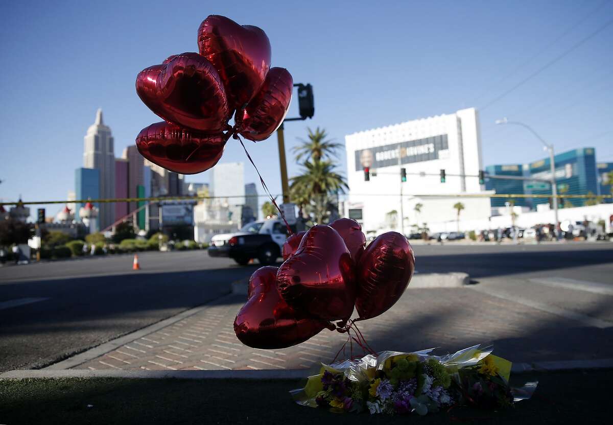 Balloons and flowers are left on the Las Vegas Strip near the site of the Route 91 Harvest Festival, where a deadly shooting left at least 59 people dead and 527 injured, Oct. 2, 2017. The gunman, identified as Stephen Paddock, rained a rapid-fire barrage on the outdoor concert festival on Sunday night, resulting in one of the deadliest mass shootings in American history. (Isaac Brekken/The New York Times)