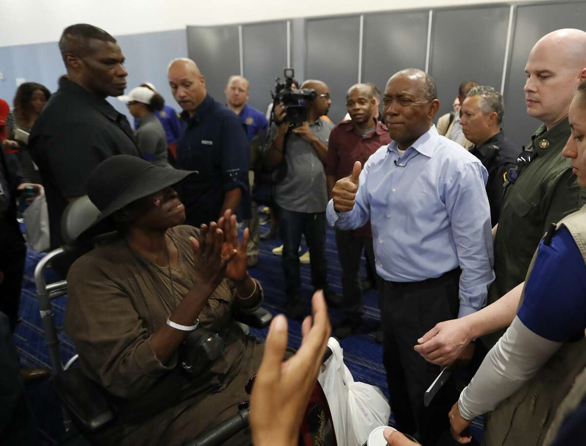 Mayor Sylvester Turner smiles as Marva Hill, who was evacuated from the Fifth Ward, and others started clapping for him at the George R. Brown Convention Center, where the Red Cross had set up a shelter for those displaced by Tropical Storm Harvey, Friday, Sept. 1, 2017, in Houston. ( Karen Warren / Houston Chronicle )