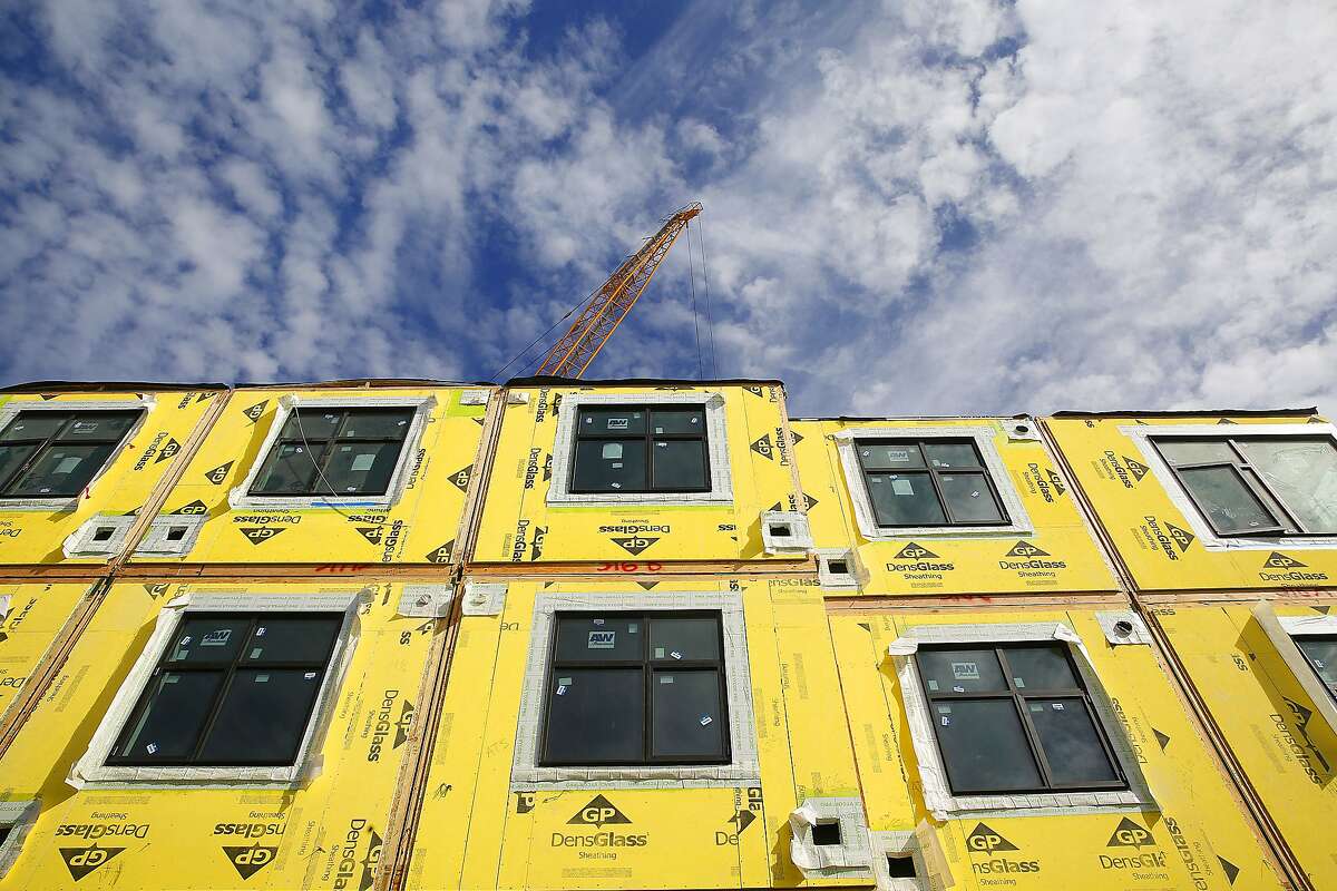 A 136-unit rental housing project takes place in the Bayview in San Francisco, Calif., on Monday, September 28, 2015. On it's sixth day, the modular housing units are a little more than a third of the way stacked as they work on four floors.