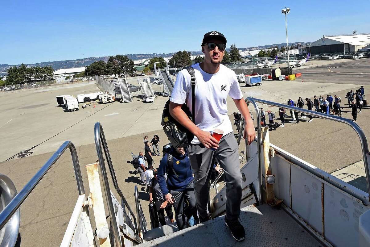 Klay Thompson boards the plane for the 2017 NBA Global Games China on Oct. 1 in Oakland.