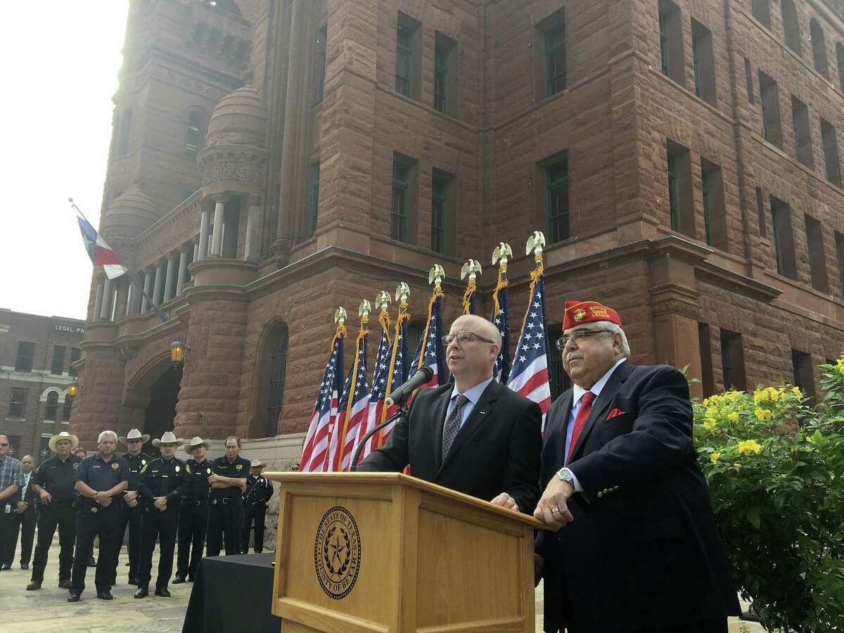 Bexar County Commissioners Kevin Wolff and Paul Elizondo speak at the unveiling of a plaque commemorating recipients of the Texas Legislative Medal of Honor. The two fought but became friends. Elizondo died recently.
