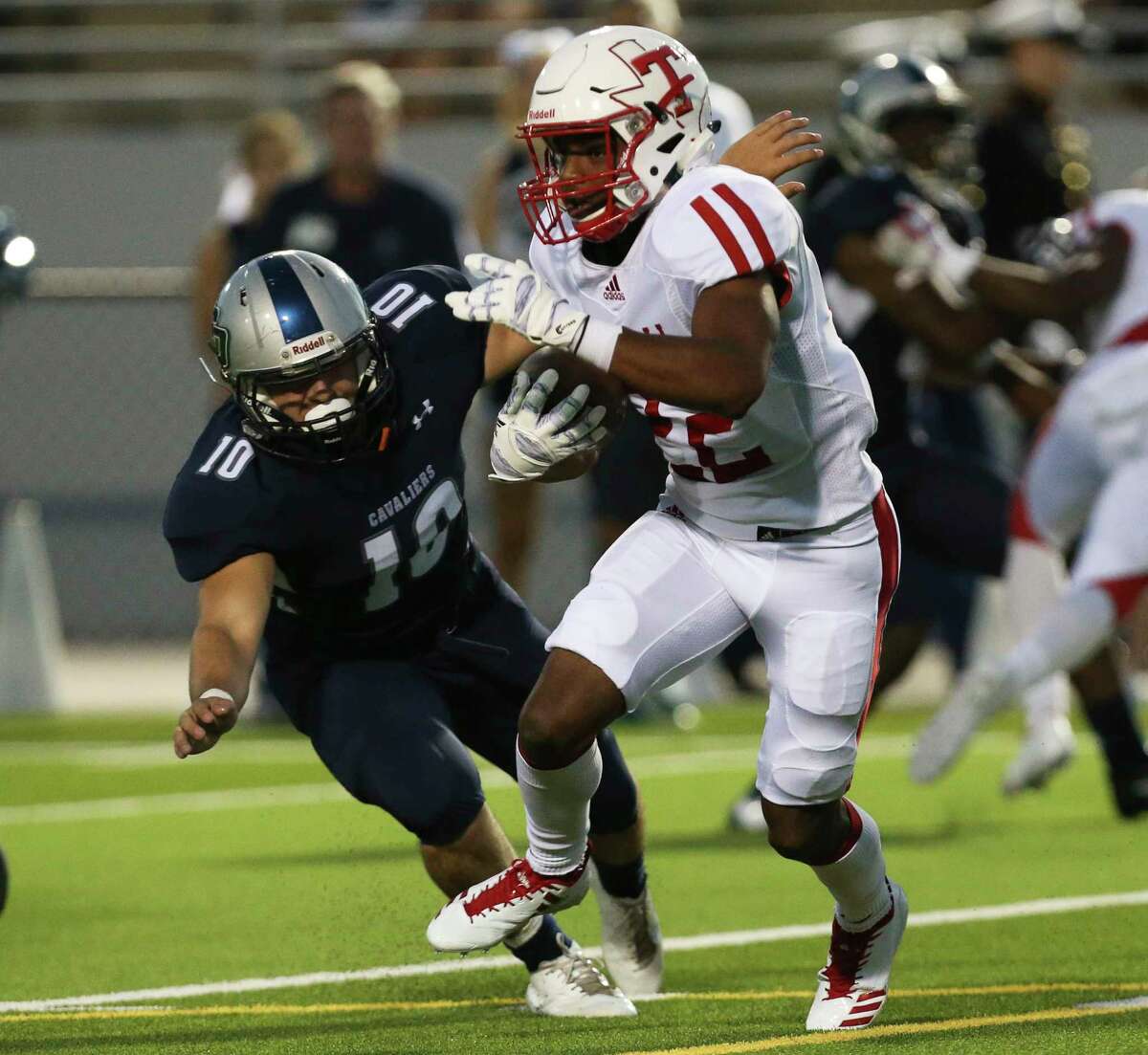 Tomball's running back Ja'Kobi Holland (22) passes College Park's linebacker Haden Stark (1) during the first half of the game at the Woodforest Bank Stadium Friday, Sept. 8, 2017, in The Woodlands. ( Yi-Chin Lee / Houston Chronicle )