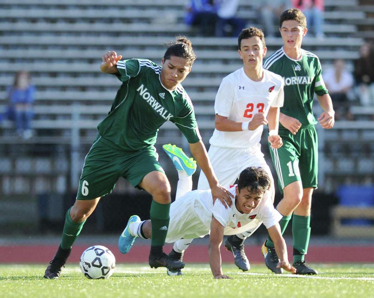 Norwalk's Lance Garcia, left, controls the ball as he pushes away Greenwich defender Christopher Cruz in the high school boys soccer game between Greenwich and Norwalk at Greenwich High School in Greenwich, Conn. Tuesday, Oct. 3, 2017.