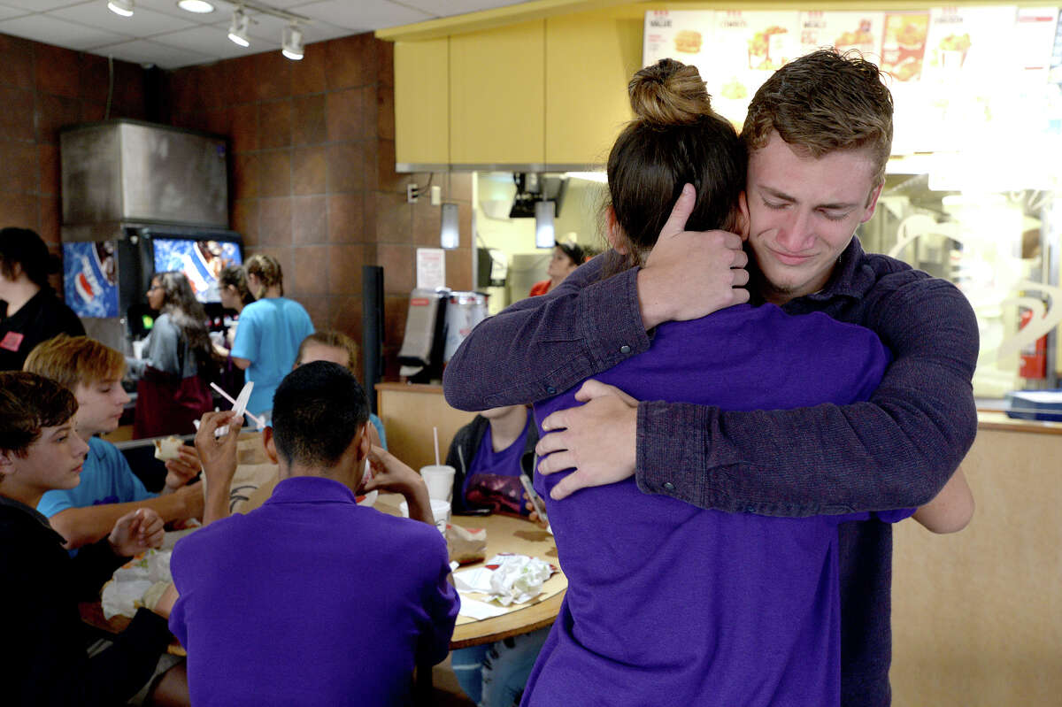 Colby Watts and Autumn Roundtree console one another as they become emotional while joining in the gathering at Taco Bell, where a number of Silsbee High School students met following a vigil in honor of Tristan Dilley at Silsbee High School Tuesday. The restaurant was Tristan's favorite, and it was quickly filled early in the evening with students wearing commemorative t-shirts, laughing as they shared memories of their friend, and consoling one another as they continue dealing with their loss. Photo taken Tuesday, October 3, 2017 Kim Brent/The Enterprise
