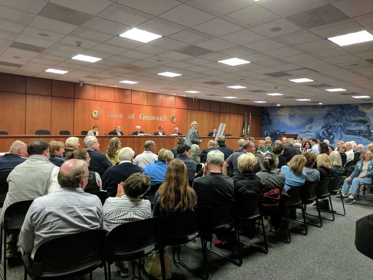Neighbors attend a meeting to discuss a proposed apartment building at 143 Sound Beach Ave. at Town Hall Tuesday night.