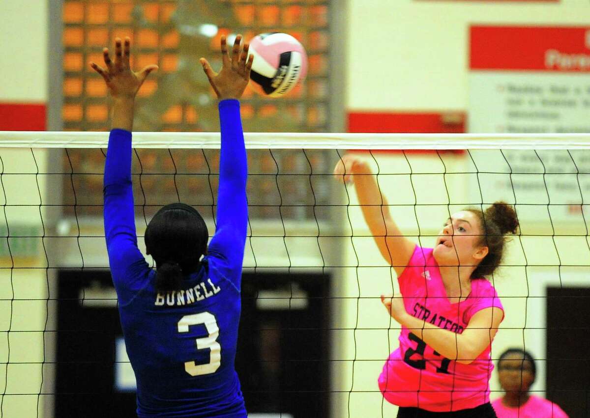 Stratford's Gillian Mariconda spikes the ball as Bunnell's Kayla Sokunle tries to block during girls volleyball action in Stratford, Conn. on Wednesday, Oct. 4, 2017.