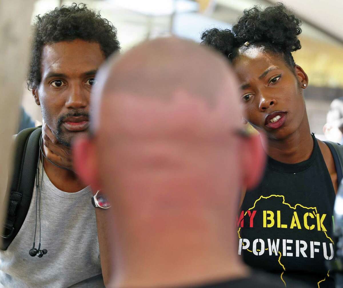 Jarrett Wright, left, and a fellow Cal student, right, who preferred to not be identified, listen to Patriot Prayer's Kyle Broussard, center, explains his stance on the Black Lives Matter movement at Sproul Plaza on the University of California at Berkeley campus on Wednesday, September 27, 2017.