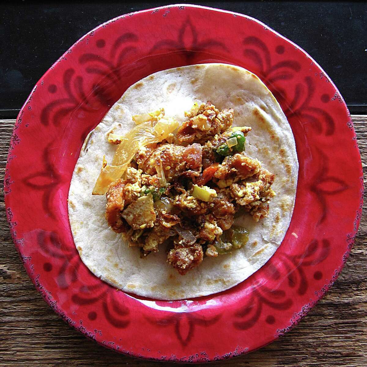 Taco of the Week: Chicharrón and egg a la mexicana taco on a handmade flour tortilla from Chaparritas Mexican Restaurant.