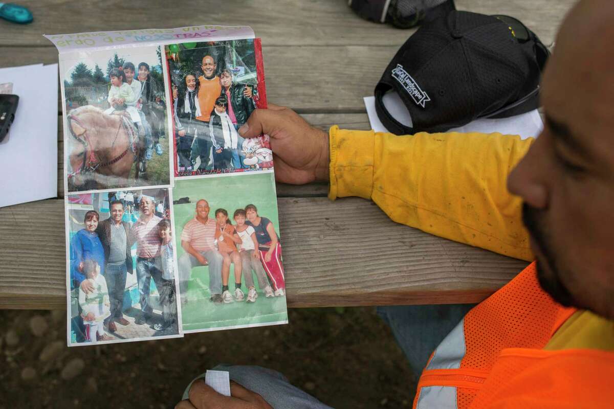Ramiro Espinoza looks at photos of his family that he found in his baggage. "You are happy when you get the call, but as it nears when you have to leave, you don't want the day to arrive," Espinoza said.