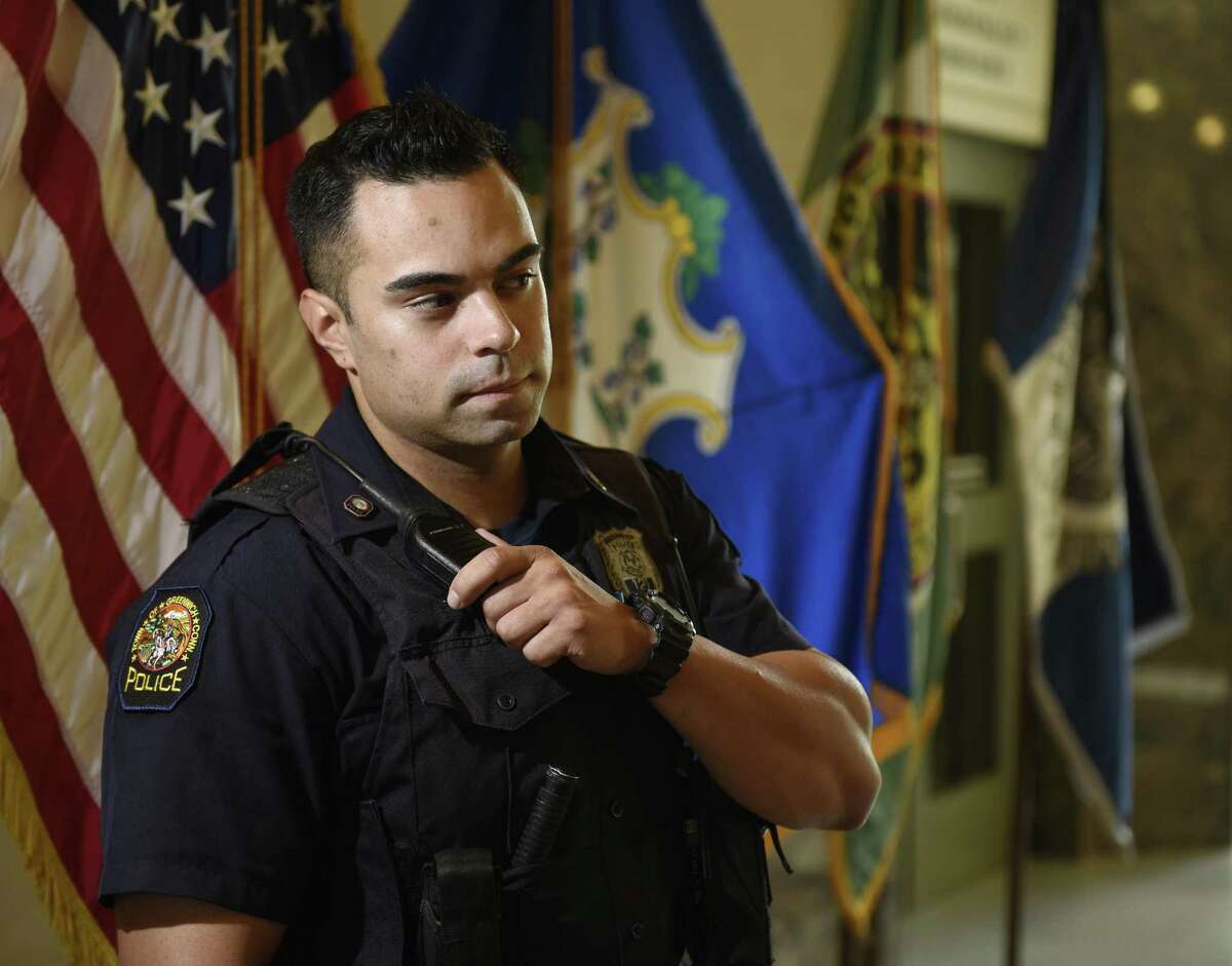 Greenwich Patrol Officer Justin Rivera poses in the lobby of the Town of Greenwich Public Safety Complex in Greenwich, Conn. Tuesday, Sept. 5, 2017.