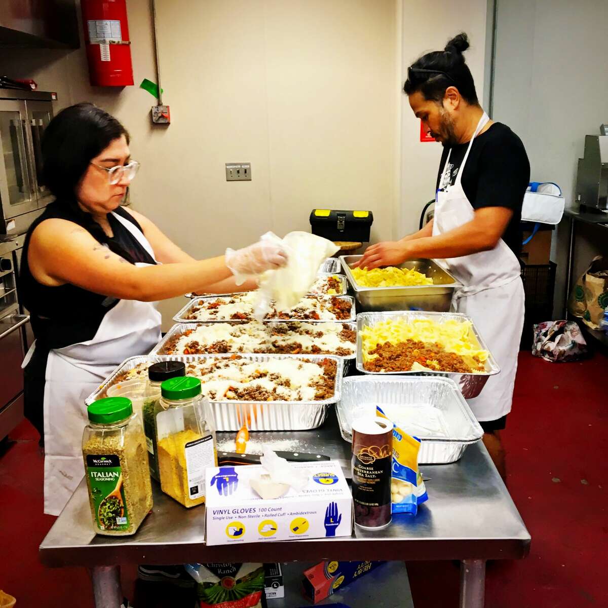 Volunteers prep meals inside the Midtown Kitchen Collective.