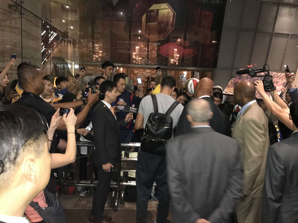 Klay Thompson signs autographs for Chinese fans outside the Warriors' hotel in Shanghai.