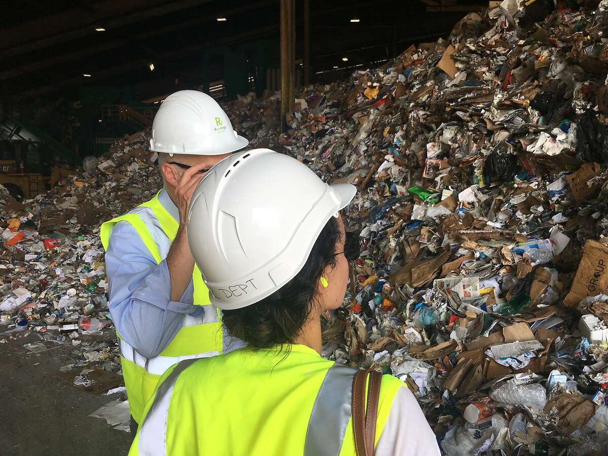 Columnist Caille Millner surveys a few hours' worth of San Francisco's recycling at Recology's recycling plant at Pier 96.