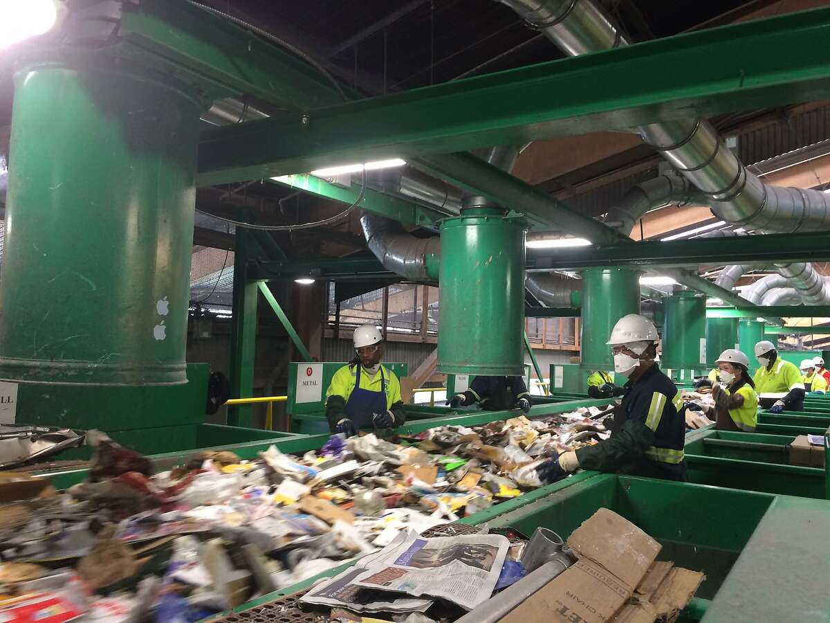 Columnist Caille Millner takes a tour of Recology's recycling plant at Pier 96 in San Francisco. Here, employees sort recycling that runs on a complex conveyer belt.