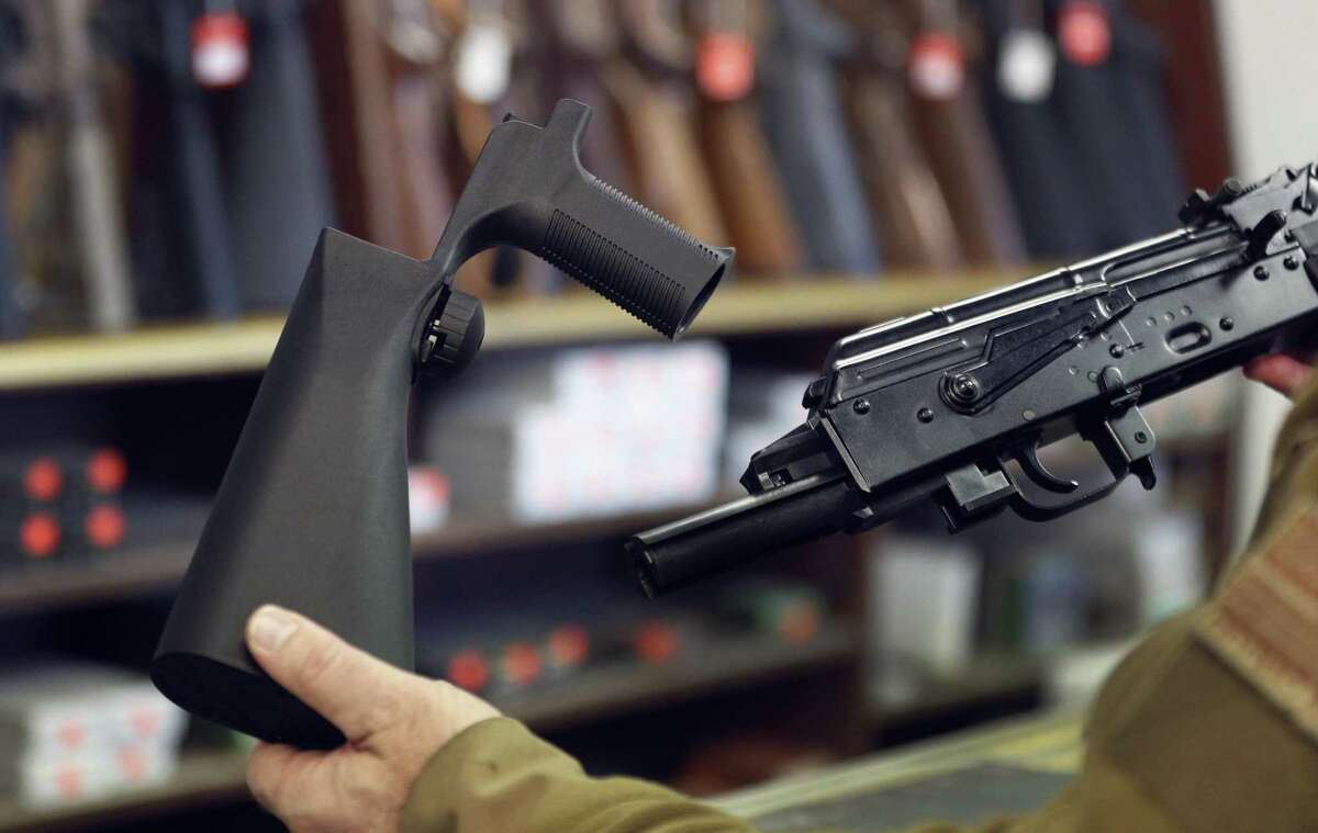 A bump stock device (left), that fits on a semi-automatic rifle to increase the firing speed, making it similar to a fully automatic rifle, is shown next to a AK-47 semi-automatic rifle (right), at a gun store on October 5, 2017 in Salt Lake City, Utah. Congress is talking about banning this device after it was reported to of been used in the Las Vegas shootings on October 1, 2017.