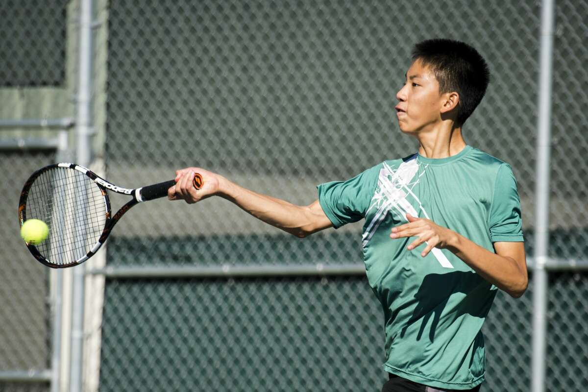 Freshman Caleb Qiu, Dow's number four singles player, returns the ball during the Saginaw Valley Boys Tennis Tournament on Thursday, Oct. 5, 2017 at the Greater Midland Tennis Center. (Danielle McGrew Tenbusch/for the Daily News)