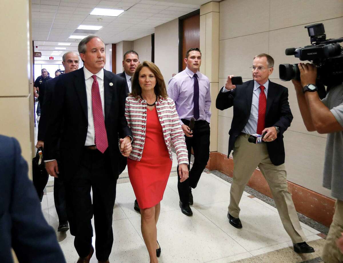 Texas Attorney General Ken Paxton leaves the 177th District Court, with his wife, Angela Paxton, earlier this year.